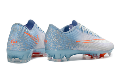 Nike Mercurial Vapor 16 Elite FG en color azul glaciar con detalles en naranja.