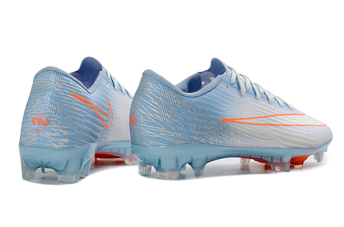 Nike Mercurial Vapor 16 Elite FG en color azul glaciar con detalles en naranja.
