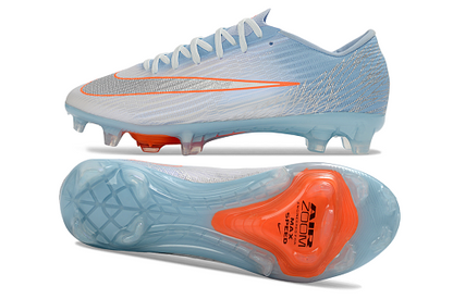 Nike Mercurial Vapor 16 Elite FG en color azul glaciar con detalles en naranja.