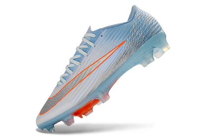 Nike Mercurial Vapor 16 Elite FG en color azul glaciar con detalles en naranja.