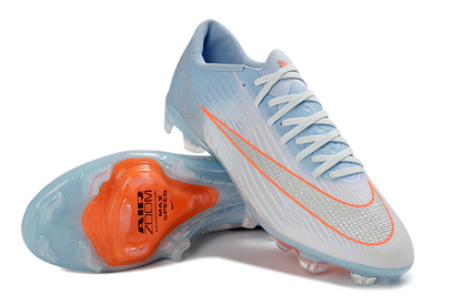 Nike Mercurial Vapor 16 Elite FG en color azul glaciar con detalles en naranja.
